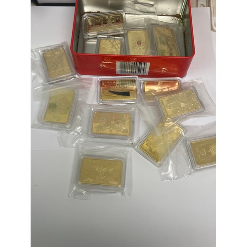 21 - A tin of commemorative collector’s bullion bars (untested), one commemorating the victims of the Tit... 