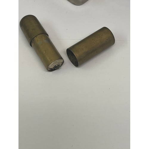 10 - Antique metal wares to include a brass and plated sovereign case, a trench art lighter a military so... 
