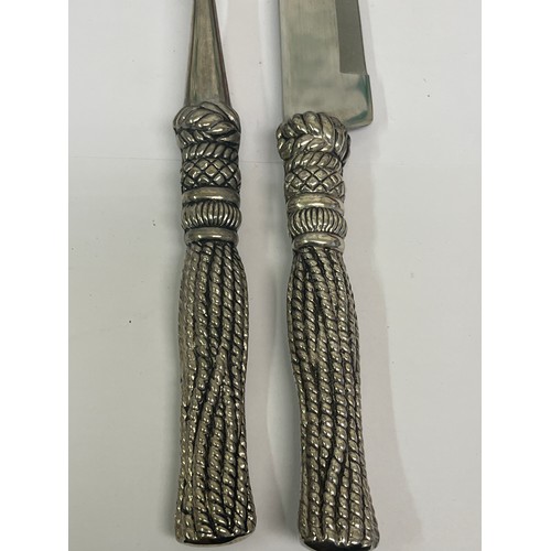 19 - A carving knife & fork set by Silea with rope tassel handles