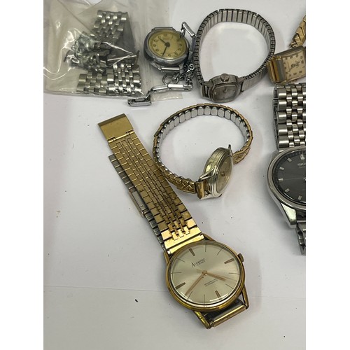 26 - Tin with contents of vintage watches. Includes an Art Deco chromium plated watch on black strap, Acc... 