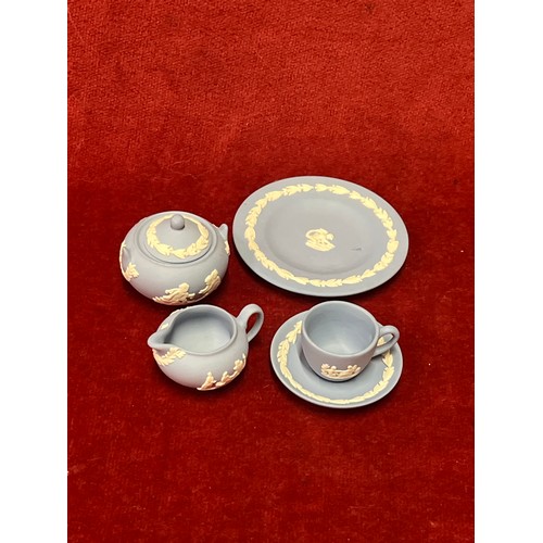 4 - Wedgwood Jasper miniature teaset together with a porcelain pincushion doll