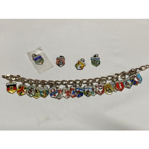 39 - A vintage 835 silver charm bracelet with enamel souvenir charms, some marked 800, also 5 loose charm... 