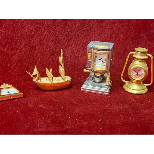 15 - Collection of gilt metal novelty clocks including telephone box, coffee machine, Tilly lamp etc