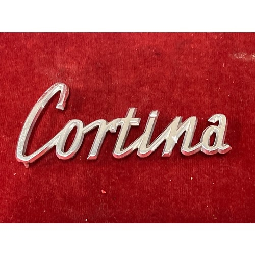 10 - Six vintage car badges etc including Wolseley, Riley , Morris, Cortina, Austin flying wing bonnet or... 