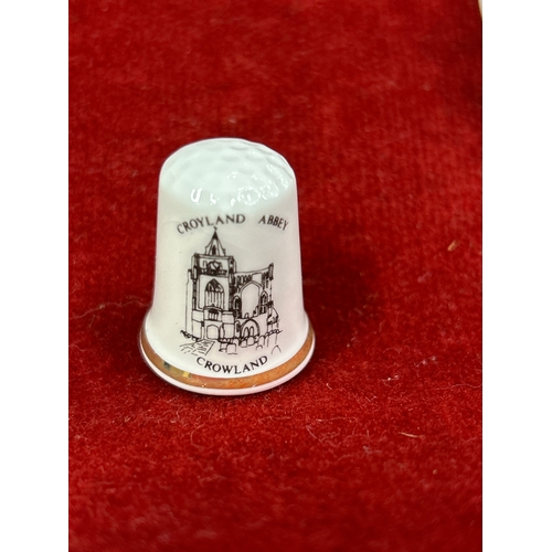 75 - Crowland Abbey, two porcelain bells by Allenway of Bourne England and 18 porcelain thimbles ‘Bone Ch... 