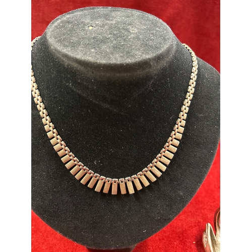 76 - Heavy sterling silver dolphin bangle and a sterling silver Cleopatra necklace. Total weight 75 grams