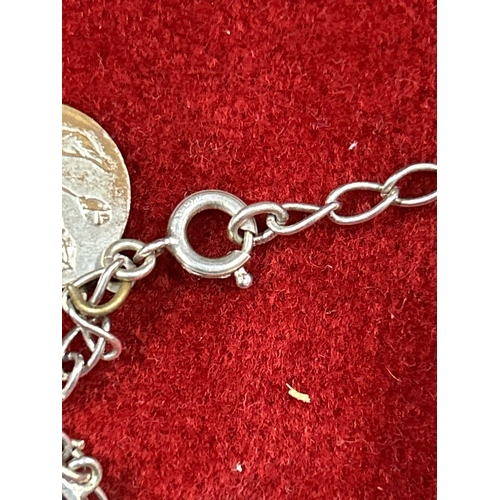 18A - Sterling silver charm bracelet with cross, donkey, keys, miniature rings. 16grams