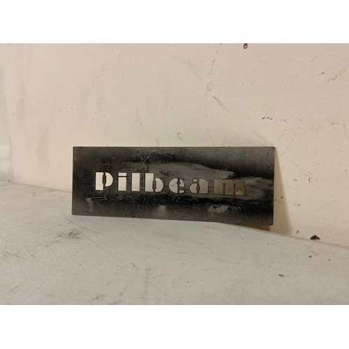 56 - ‘Pilbeam’ racing brand workshop steel stencil, along with a machined ‘Pilbeam’ aluminium plaque. Ste... 