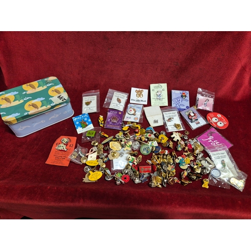 76 - Tin of various pin badges