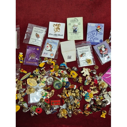 76 - Tin of various pin badges