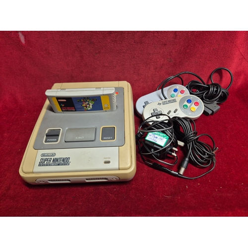 103 - SNES Super Nintendo Entertainment System with Super Mario World game, controllers and power supply