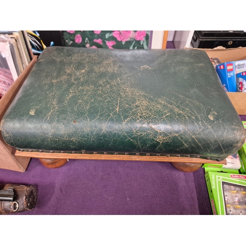 111 - Large footstool with green distressed leather top and solid oak bun feet