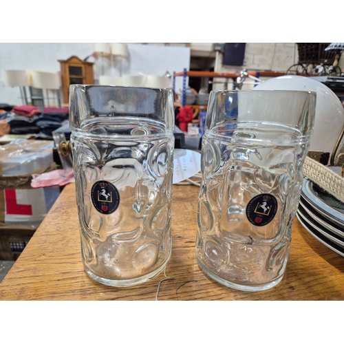 207 - Metal magazine rack side table and a box of mostly glass tankards etc plus some brass