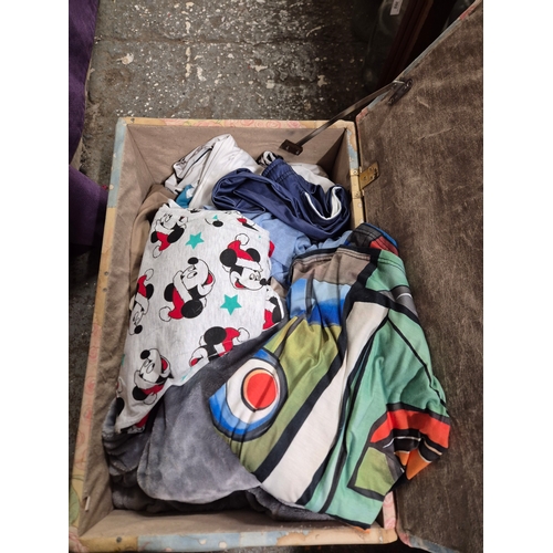 209 - Bear ottoman with contents of Ladies clothing large sizes and bedding including a Mickey Mouse bed s... 