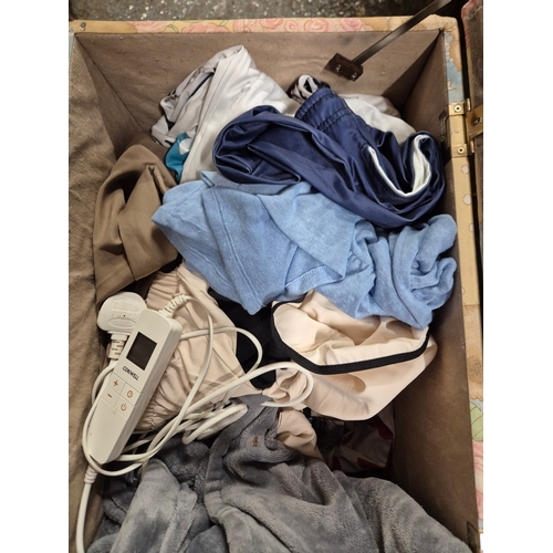 209 - Bear ottoman with contents of Ladies clothing large sizes and bedding including a Mickey Mouse bed s... 