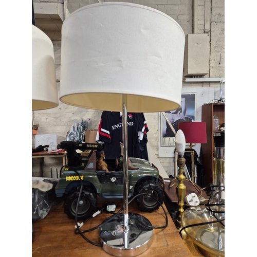 217 - Pair of chrome based table lamps with cream shades