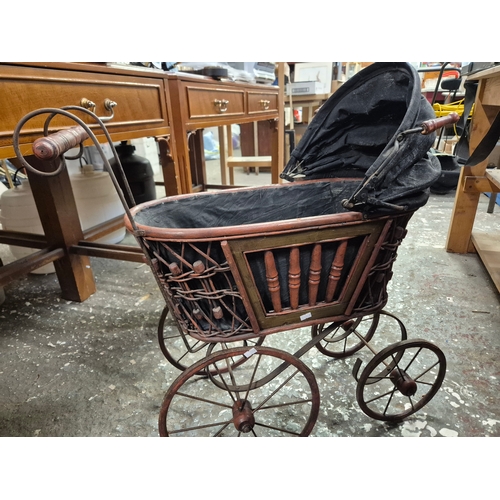 244 - 1920'S reproduction doll's pram with metal and wicker frame and folding canopy