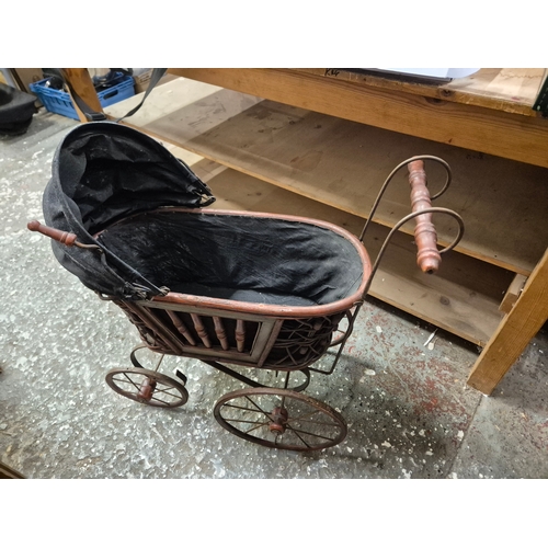 244 - 1920'S reproduction doll's pram with metal and wicker frame and folding canopy