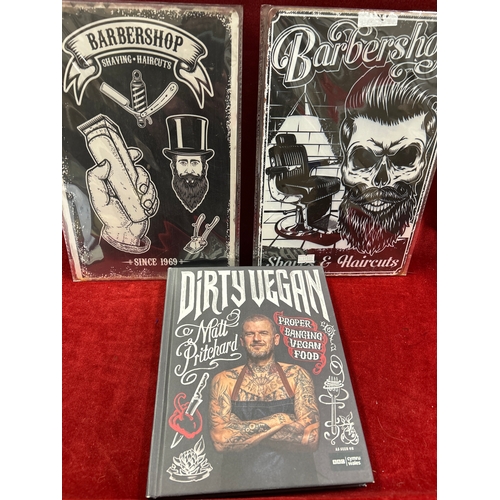 62 - Two metal barbershops signs and a hardback book ‘Dirty Vegan’ by Matt Pritchard