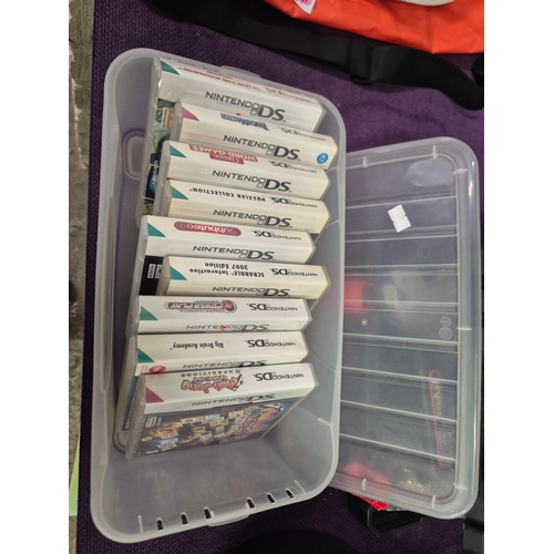 Plastic box with contents of Nintendo DS games