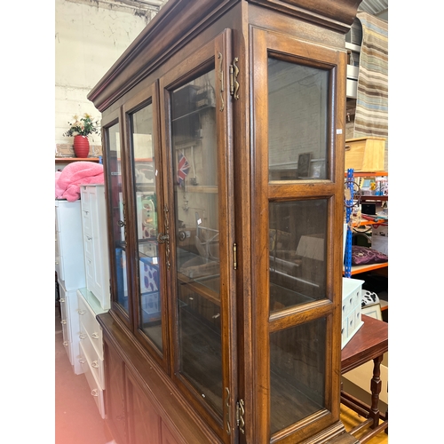 308 - Large display cabinet with glass doors and 3 lower cupboards inside concealing a cutlery tray, decor... 