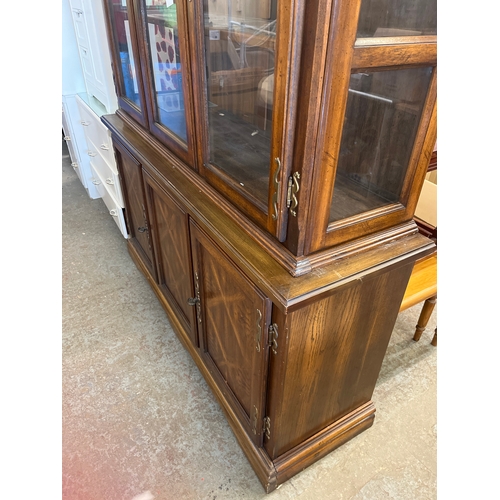 308 - Large display cabinet with glass doors and 3 lower cupboards inside concealing a cutlery tray, decor... 