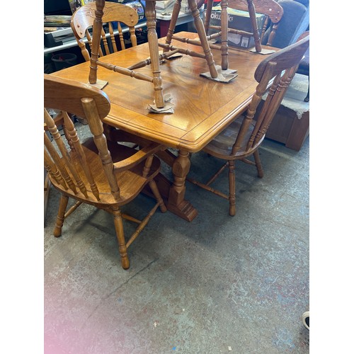 309 - Solid Oak dining table 4 spindle chairs and 2 carvers with delicate  carved panels