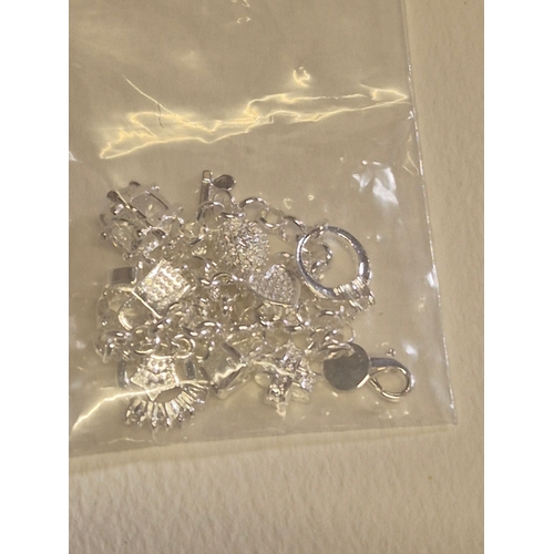 42 - 3 packs of white metal charms