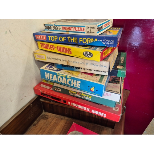Stack of vintage board games and puzzles