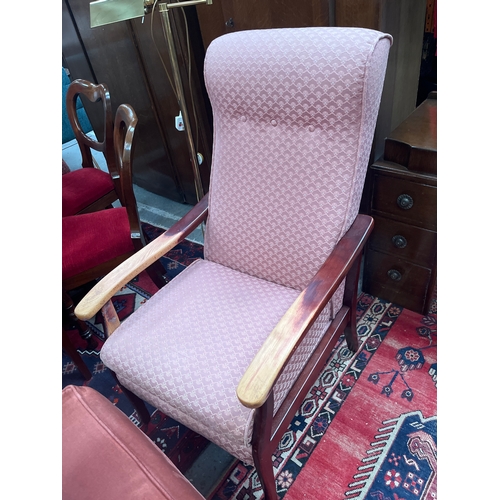 306 - Parker knoll high back chair with wooden arms and upholstered in  pink shell style fabric