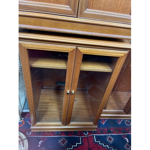 309 - Mid-century G Plan teak panelled cabinet paired with a matching glass-fronted music or display cabin... 