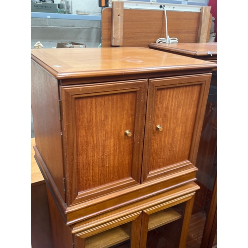 309 - Mid-century G Plan teak panelled cabinet paired with a matching glass-fronted music or display cabin... 