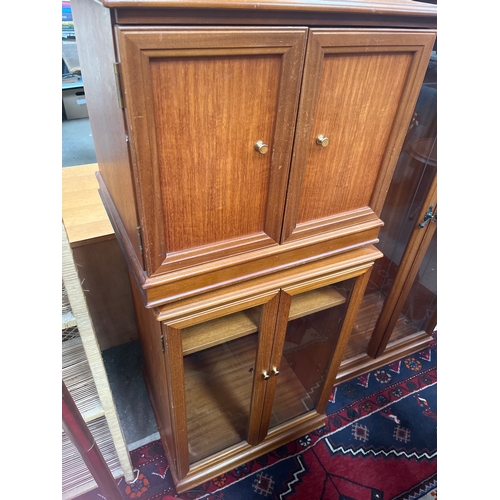 309 - Mid-century G Plan teak panelled cabinet paired with a matching glass-fronted music or display cabin... 