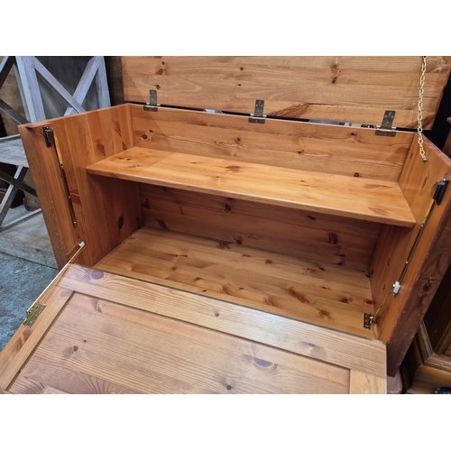 420 - Pine storage ottoman with fitted interior shelf, lift up lid and drop down front