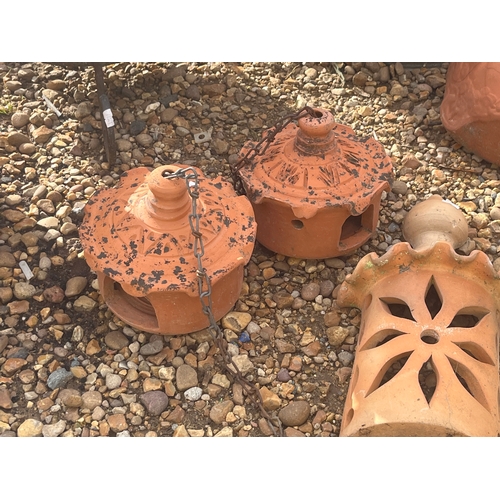 411 - Pair of terracotta pagoda candleholders and a terracotta wall plaque
