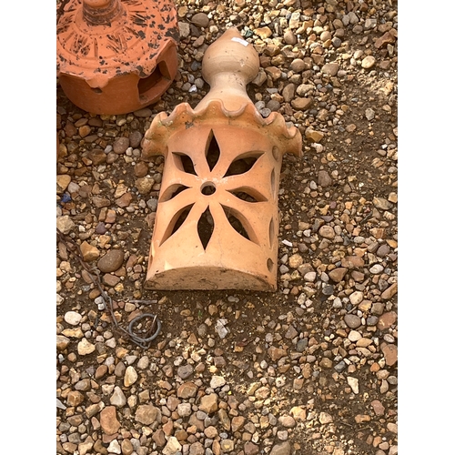 411 - Pair of terracotta pagoda candleholders and a terracotta wall plaque
