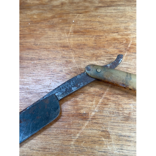 63 - Antique straight (cut throat) razor, with horn scales inscribed 1787, housing a &ldquo;wedge