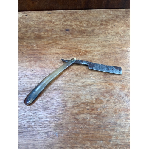 63 - Antique straight (cut throat) razor, with horn scales inscribed 1787, housing a &ldquo;wedge