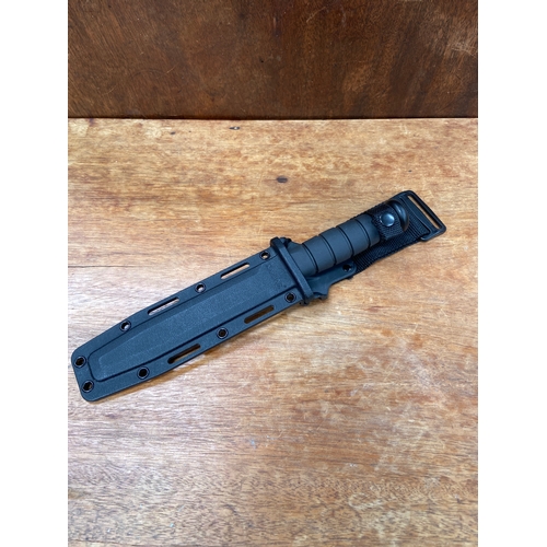 38 - KA-BAR 1211 USMC Fighting/Utility knife, featuring a 7-inch partially serrated carbon steel blade wi... 