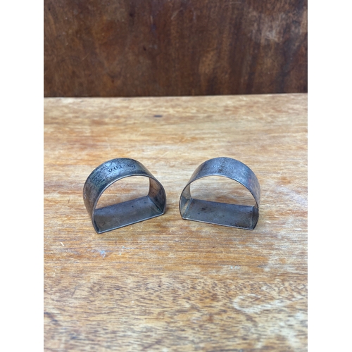 43 - Pair of sterling silver flat sided napkin rings, bearing old English/gothic engraved initials to the... 