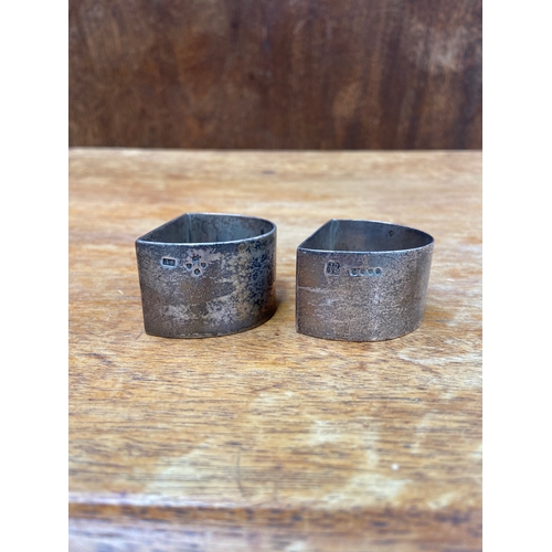 43 - Pair of sterling silver flat sided napkin rings, bearing old English/gothic engraved initials to the... 