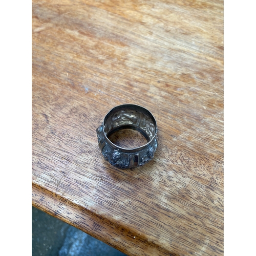 45 - Antique sterling silver napkin ring from British India, early 20thC featuring intricate repoussé dec... 