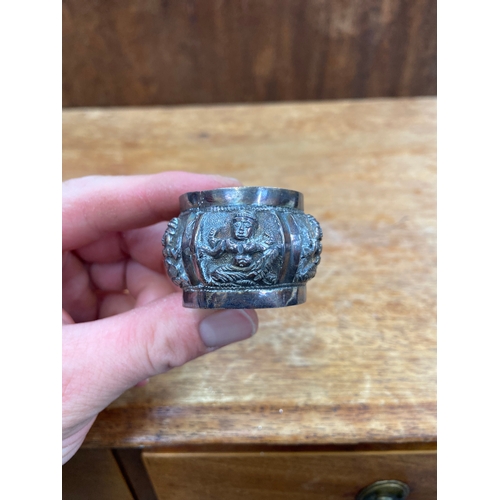 45 - Antique sterling silver napkin ring from British India, early 20thC featuring intricate repoussé dec... 