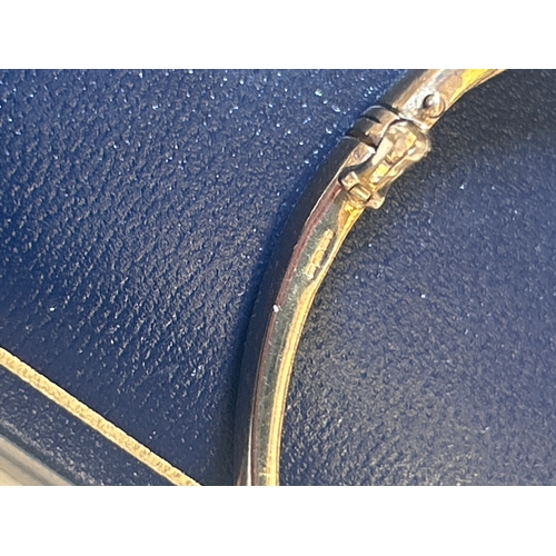 29 - 9ct gold bracelet set with diamond chips in a spiral design. 12.7 grams. Slightly misshapen but catc... 