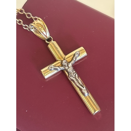 34 - Silver and 9ct bonded gold crucifix on chain, the box marked Chisholm & Hunter 1857