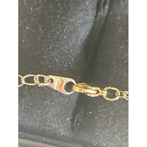 34 - Silver and 9ct bonded gold crucifix on chain, the box marked Chisholm & Hunter 1857