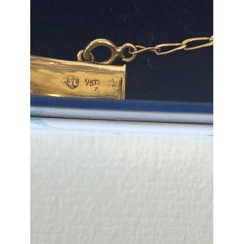 36 - Vintage 18ct rolled gold bangle engraved with foliate design. Marked 1/5 t 18ct. The safety chain is... 