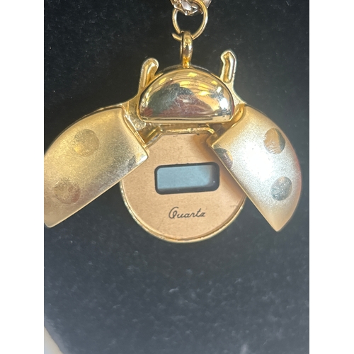 37 - Selection of gold plated necklaces and a ladybird pendant watch