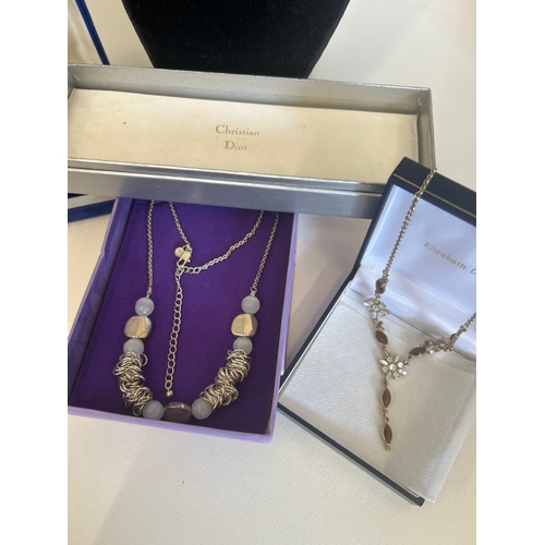 38 - Selection of costume jewellery necklaces & charm bracelet . Includes original Christian Dior box... 