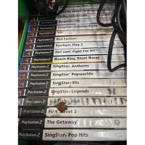 Sony PlayStation 2 console bundle with a stack of PS2 games, SingStar ...